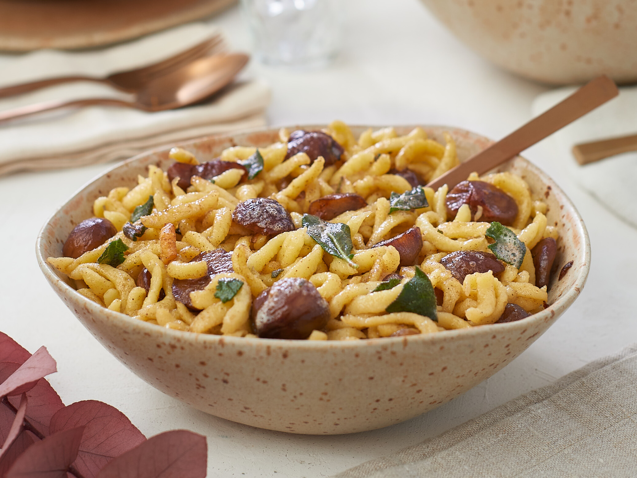 Eine Schüssel Pasta mit Fleischbällchen auf einem Tisch.